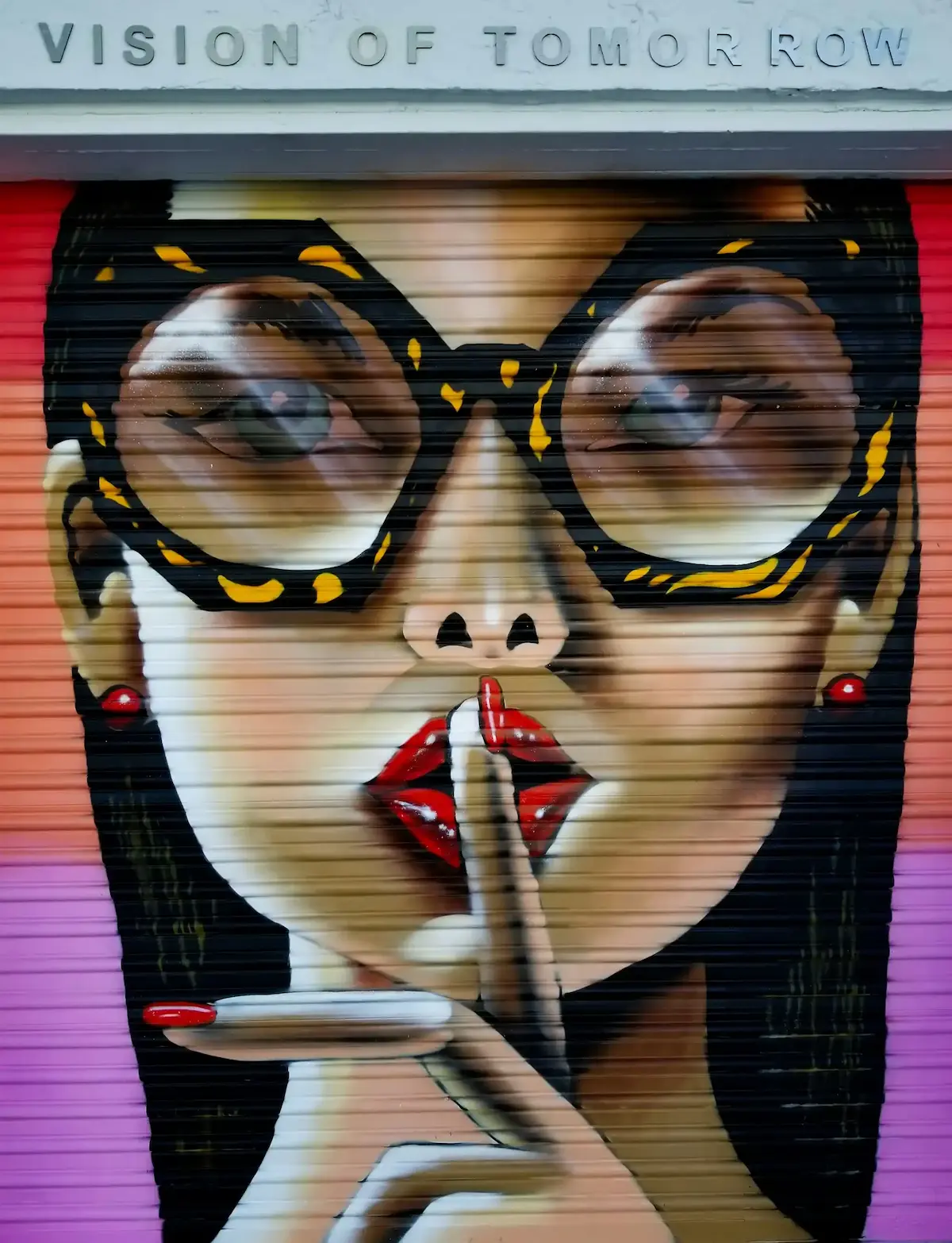 Stylized mural of a woman with leopard glasses making a shushing gesture